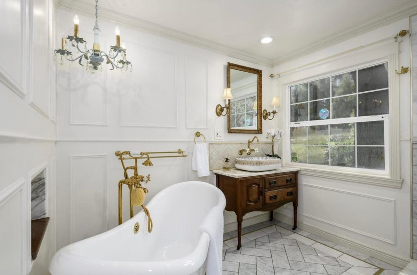 Bright finished Victorian-inspired bathroom in the California farmhouse
