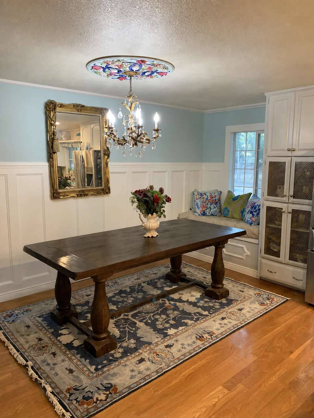 California farmhouse dining room connected through color and collected furnishings