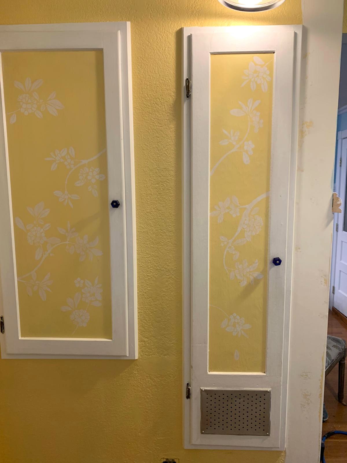 Paired floral-painted doors for the antique ironing board and breaker panel in the earlier yellow entry