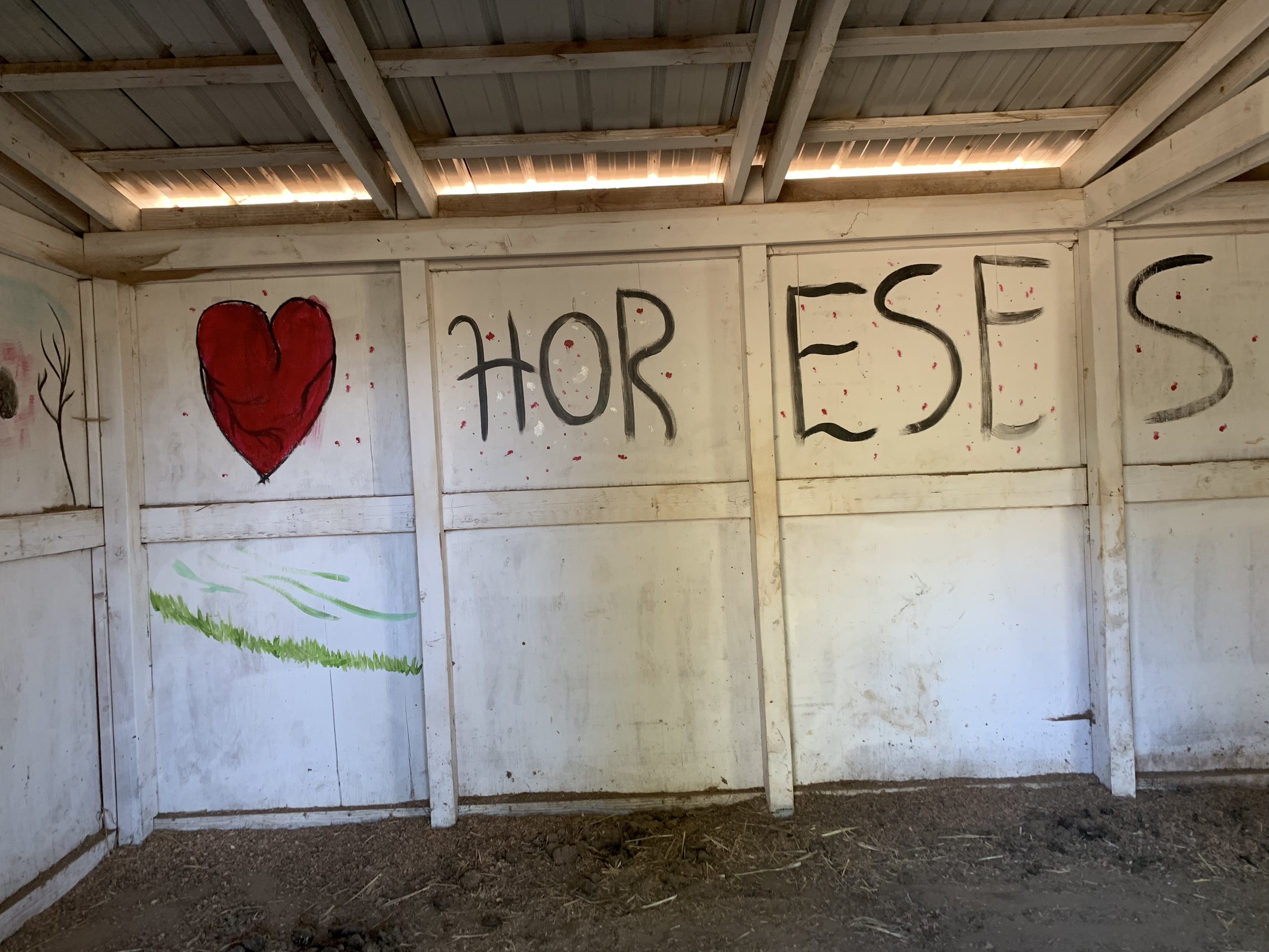 Painted horse stall wall with a heart and the word horses