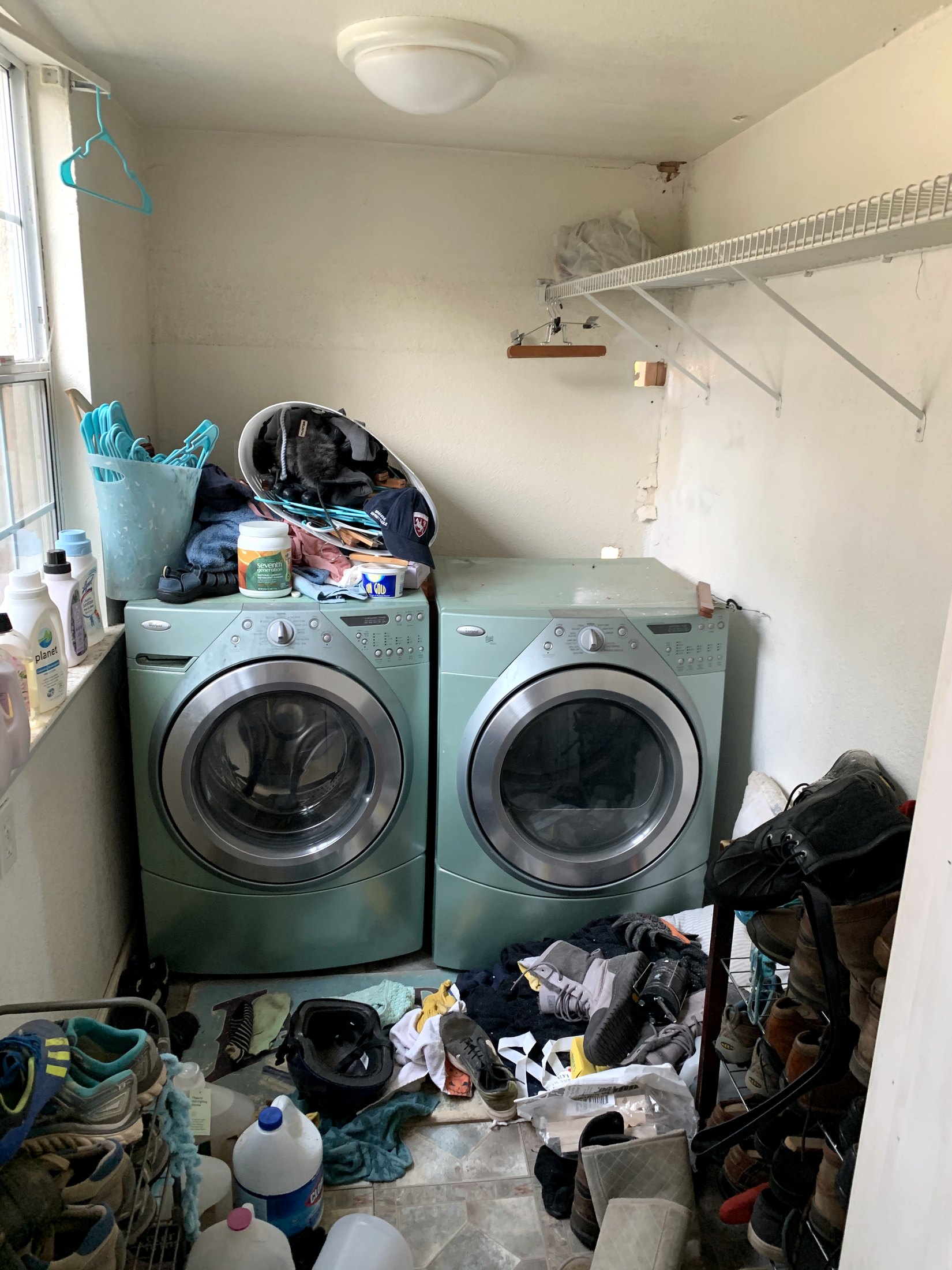 Original crowded laundry room before renovation