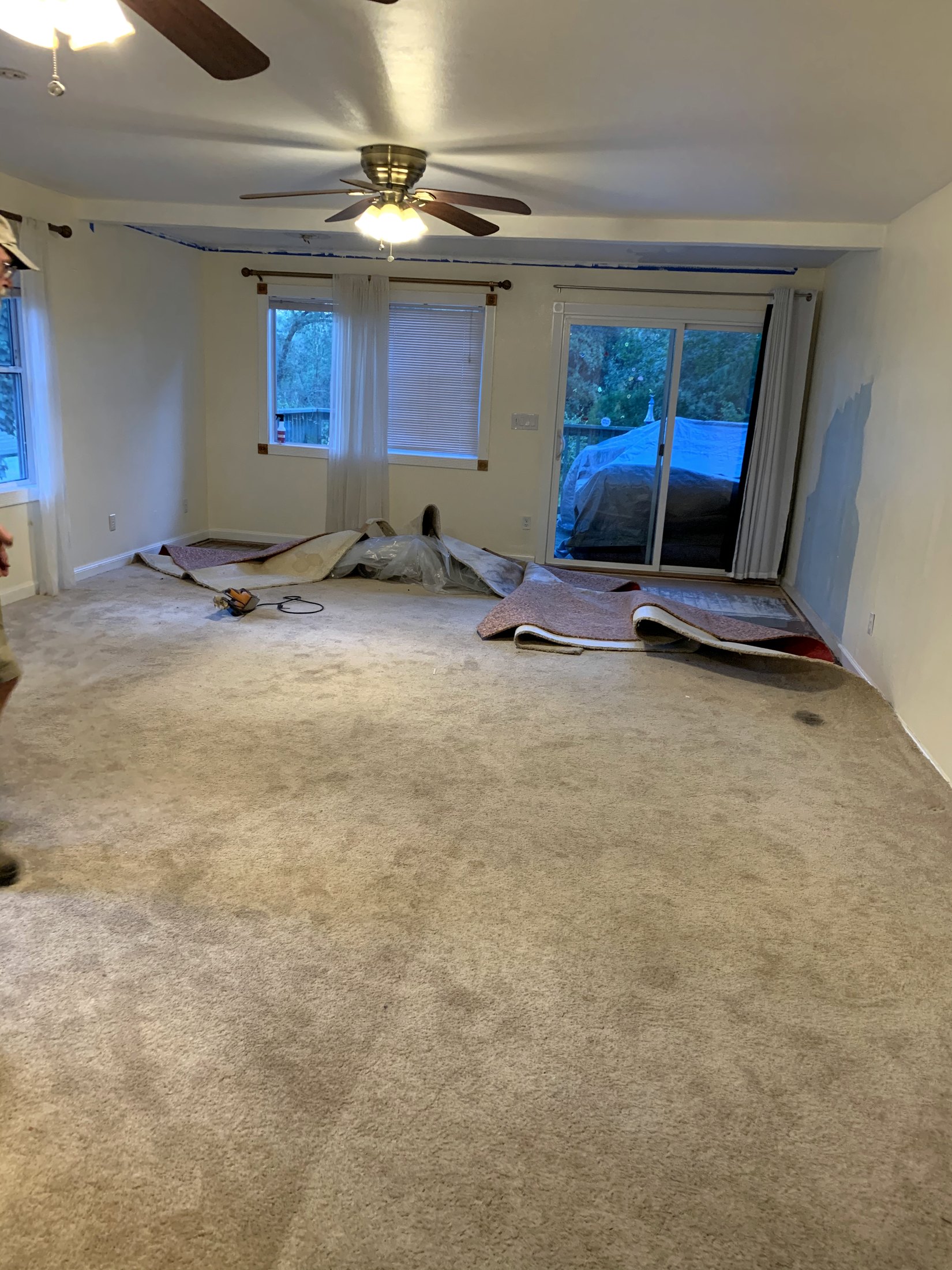Original living room as its beige carpet was being lifted