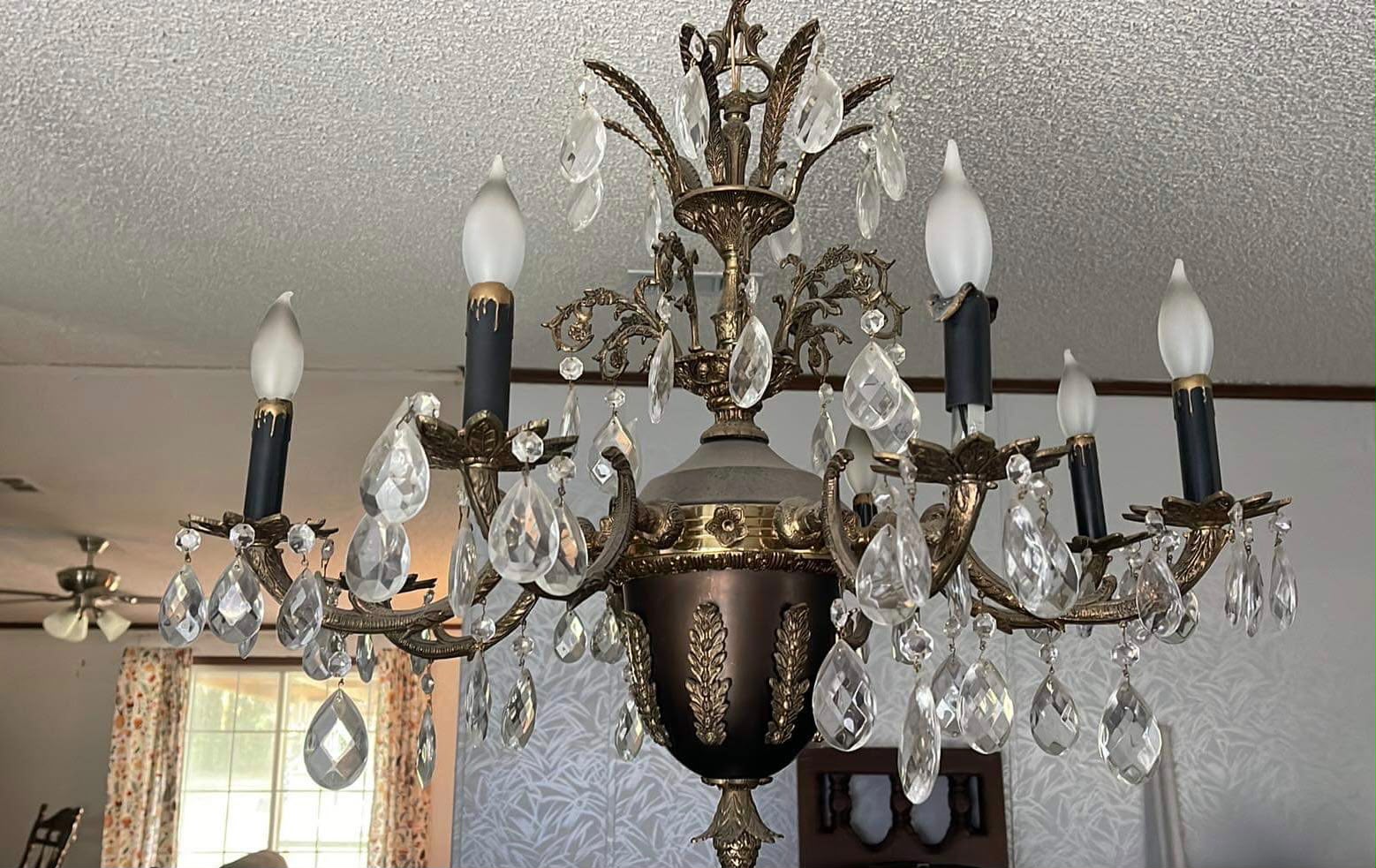 Antique chandelier hanging before restoration